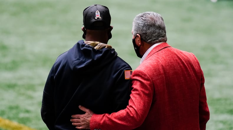 Falcons owner Arthur Blank embraces interim head coach Raheem Morris during a home game in 2020. (AP file photo)