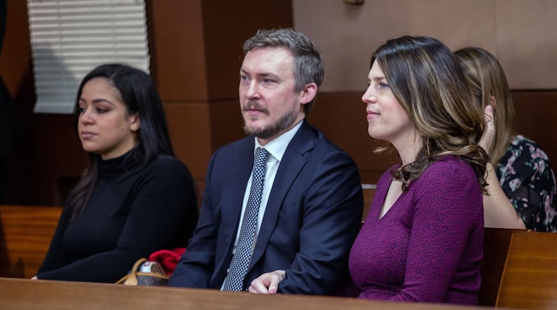 Jenna Garland, right, and her husband, Simeon Spearman, sit next to Anne Torres, Garland’s former boss and former Mayor Kasim Reed’s director of communications, during a pre-trial hearing Monday in the Fulton County Courthouse. Garland has been charged with two misdemeanor counts of violating the Georgia Open Records Act. STEVE SCHAEFER / SPECIAL TO THE AJC