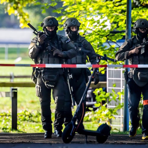 Armed police officers patrol near the Schachen horse racing track in Aarau following a shooting during a rave event near Aarau, Switzerland, Sunday, Aug. 30, 2026. (Michael Buholzer/Keystone via AP)