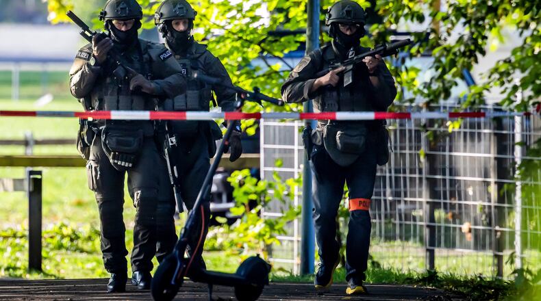 Armed police officers patrol near the Schachen horse racing track in Aarau following a shooting during a rave event near Aarau, Switzerland, Sunday, Aug. 30, 2026. (Michael Buholzer/Keystone via AP)