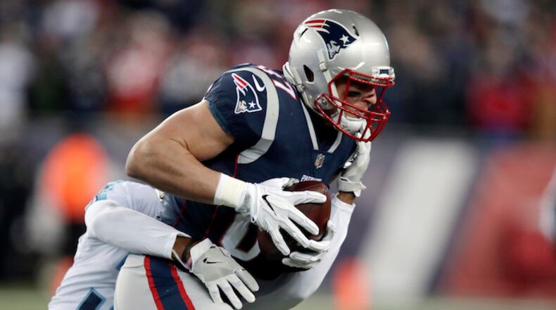 New England Patriots tight end Rob Gronkowski is tackled by Tennessee Titans safety Kevin Byard, rear, after catching a pass during the first half of an NFL divisional playoff football game, Saturday, Jan. 13, 2018, in Foxborough, Mass. (AP Photo/Charles Krupa)