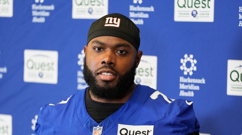 FILE - New York Giants' Andrew Thomas speaks to reporters after NFL football practice in East Rutherford, N.J., May 21, 2026. (AP Photo/Seth Wenig, file)