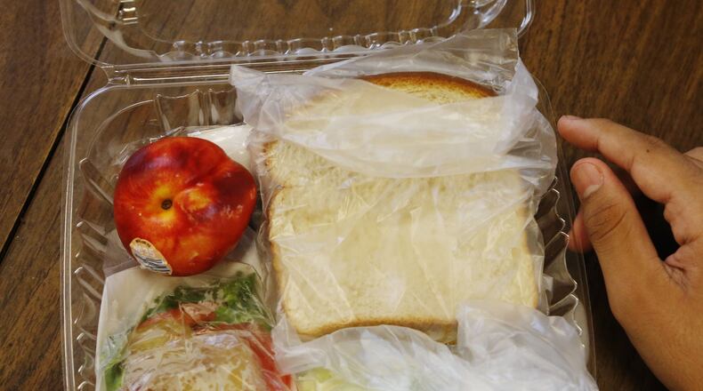 Today’s lunch. Dekalb County food-service employees prepare more than 4,000 lunches daily at Mary McLeod Bethune Middle School. About 70 percent of students in metropolitan Atlanta get free or reduced-price lunches during school months, and the schools serve lunches to many of those children through the summer. BOB ANDRES / BANDRES@AJC.COM