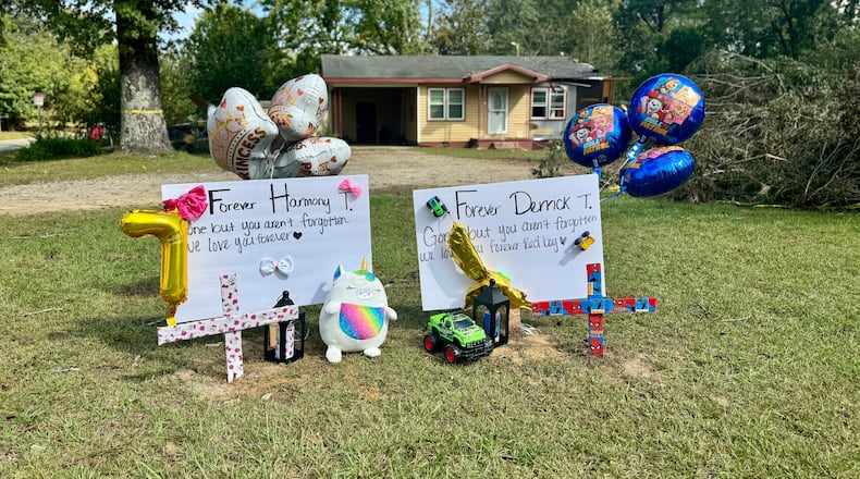 Memorial placards to Harmony Taylor, 7, and Derrick Taylor, 4, who were killed when a tree crashed down on their house on South Hospital Road in Sandersville, Georgia early Friday. (Joe Kovac Jr. / AJC)