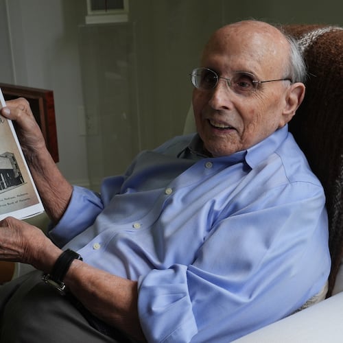 Raul Valdes-Fauli holds a picture of the family-owned Pedroso Bank in Havana during an interview Tuesday, April 21, 2026, in Coral Gables, Fla. (AP Photo/Marta Lavandier)