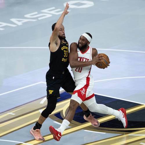 Houston Rockets guard Josh Okogie is guarded by Golden State Warriors guard Stephen Curry during the first half of an Emirates NBA Cup basketball game Wednesday, Nov. 26, 2025, in San Francisco. (AP Photo/Benjamin Fanjoy)