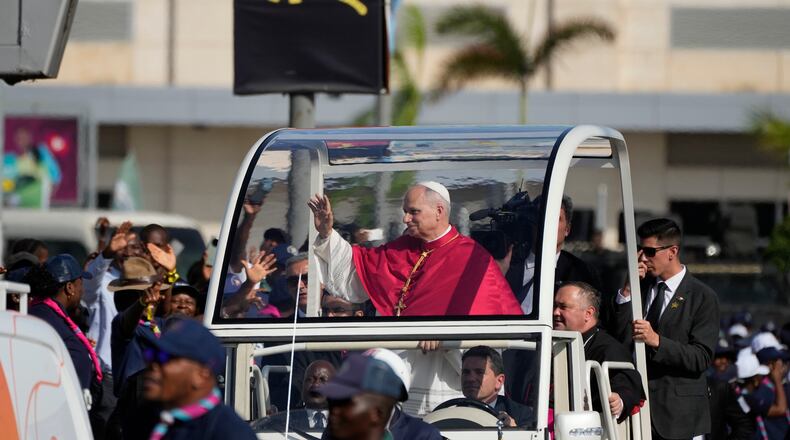Pope Leo XIV waves after arriving in Luanda, Angola, Saturday, April 18, 2026 on the sixth day of his 11-day pastoral visit to Africa. (AP Photo/Themba Hadebe)