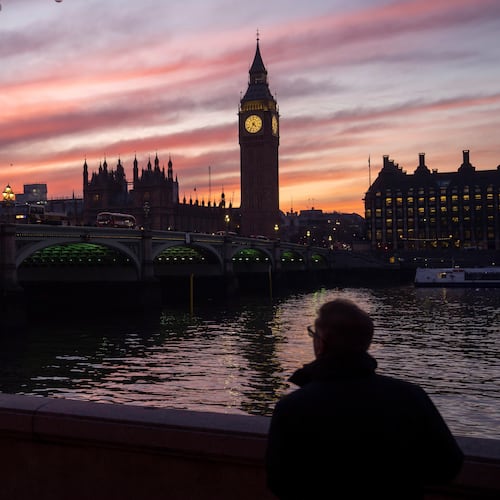 FILE - A man walks along the south bank of the River Thames backdropped by the Elizabeth Tower, known as Big Ben, of the Houses of Parliament, in London, Tuesday, Jan. 17, 2023. (AP Photo/Kin Cheung, File)