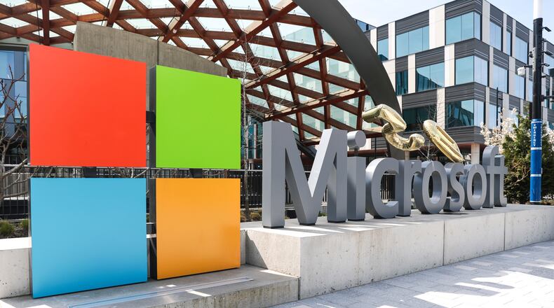 FILE - A Microsoft sign and logo are displayed at the company's headquarters April 4, 2025, in Redmond, Wash. (AP Photo/Jason Redmond, File)