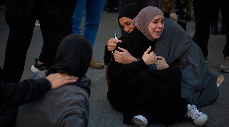 Mourners react during the funeral of 13 state security officers killed the previous day in an Israeli strike in Lebanon's coastal city of Sidon, Saturday, April 11, 2026. (AP Photo/Emilio Morenatti)