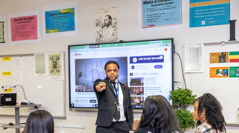 Rashad Brown teaches Advanced Placement African American Studies at Maynard Jackson High School on Friday, Feb. 17, 2023. Students participate in dialogue and debate, present projects and consider why restrictions are being put on the course in other states. (Jenni Girtman for The Atlanta Journal-Constitution)