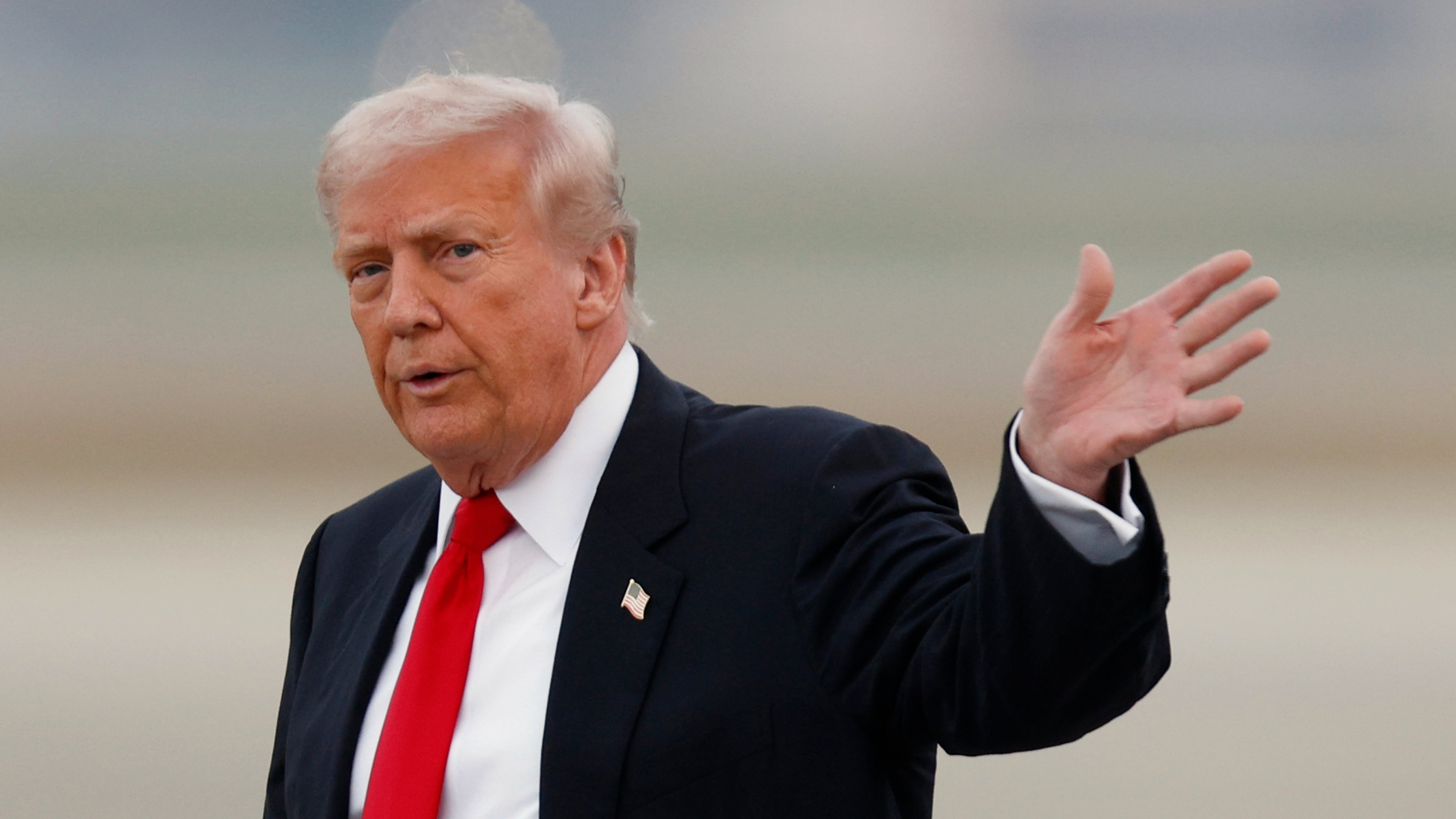 President Donald Trump waves after speaking to the media upon his arrival at Joint Base Andrews, Md., Sunday, Nov. 9, 2025, after returning from his Mar-a-Lago estate in Palm Beach, Fla. and en route to an NFL football game between the Washington Commanders and the Detroit Lions. (AP Photo/Luis M. Alvarez)