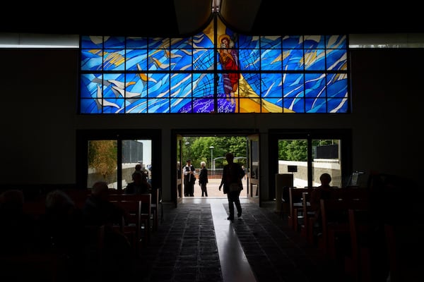 Faithful enter for a mass in San Paolo Della Croce parish church in Corviale neighbourhood, in Rome, Sunday, May 4, 2025. (AP Photo/Alessandra Tarantino)