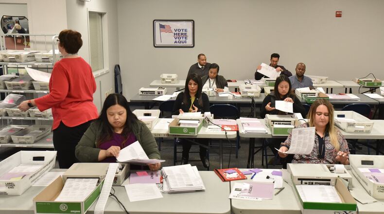 Gwinnett County poll workers count provisional ballots at Gwinnett County Voter Registrations and Elections Office in Lawrenceville on Tuesday, November 13, 2018. HYOSUB SHIN / HSHIN@AJC.COM