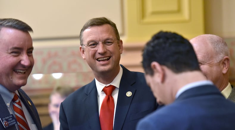 U.S. Rep. Doug Collins, R-Gainesville, (second from left) chats with Sens. Frank Ginn (left) and Butch Miller (right) on the floor of the Georgia Senate on March 3, 2017. HYOSUB SHIN / HSHIN@AJC.COM