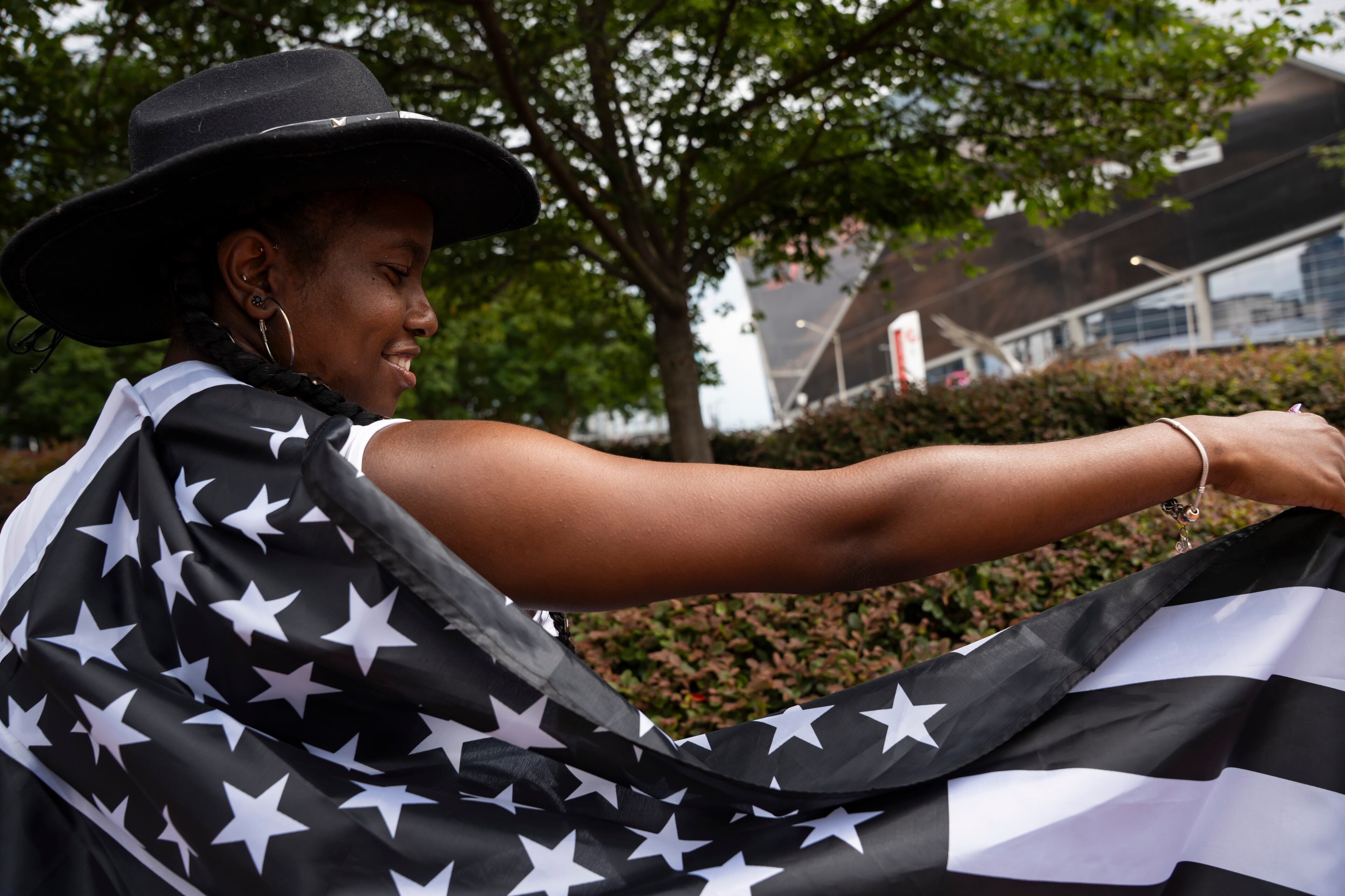 Trinity Ruffin extends her American flag cape in line outside Beyoncé's Cowboy Carter concert in Atlanta on Thursday, July 10, 2025. (Olivia Bowdoin for the AJC)