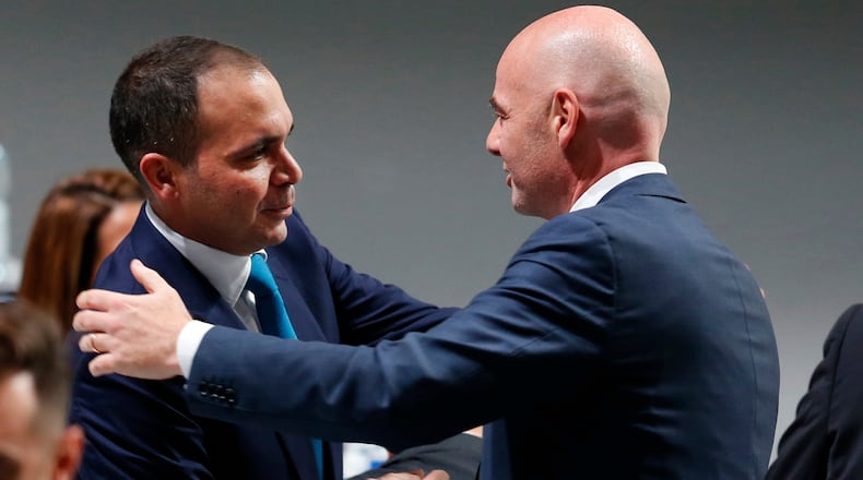 FILE - Newly elected FIFA President Gianni Infantino, of Switzerland, right, is congratulated by fellow candidate Prince Ali Al-Hussein, of Jordan, left, after the second election round during the extraordinary FIFA congress in Zurich, Switzerland, Feb. 26, 2016. (AP Photo/Michael Probst, File)