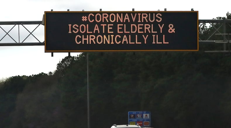 A Georgia DOT sign along I-285 warns motorists to isolate the elderly and chronically ill from the coronavirus on Monday, March 16, 2020, in Atlanta. Curtis Compton ccompton@ajc.com