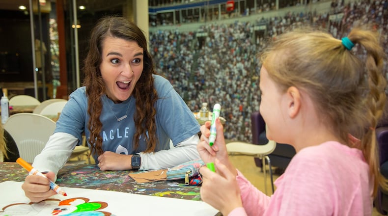 University of North Georgia student & childhood cancer survivor Heather Callahan-Williams (left) colors a turkey with Amelia Russell (age 10) in the Child Life Zone at Children’s Healthcare of Atlanta Scottish Rite in Atlanta. She started a fundraising group called Miracle UNG that recently hosted a 5k fundraiser on the Dahlonega campus. The organization also started a Dance Marathon on her campus that’s raised more than $100,000 for the hospital. (Photo by Phil Skinner)