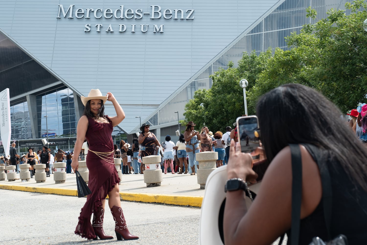 Tatyana Stevenson poses for a photo in front of Mercedes-Benz Stadium on Friday, July 11, 2025, while waiting for the gates to open for for Beyoncè’s “Cowboy Carter” show.  Ben Gray for the Atlanta Journal-Constitution