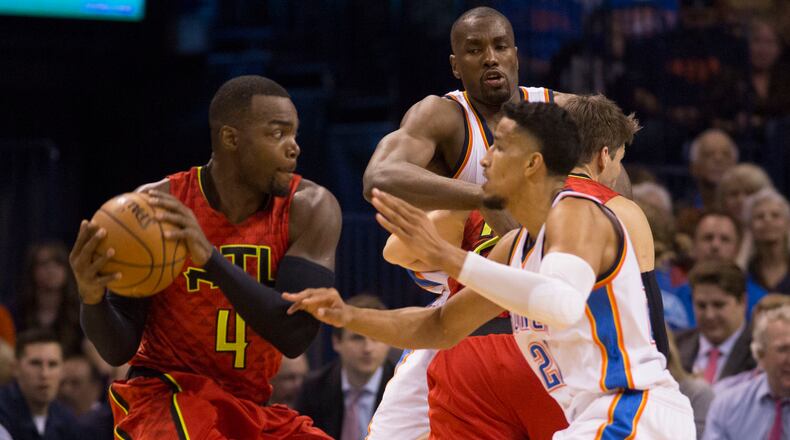 Oklahoma City Thunder guard Andre Roberson (21) tries to block Atlanta Hawks forward Paul Millsap (4) during the first half of an NBA basketball game in Oklahoma City, Thursday, Dec.10, 2015. (AP Photo/J Pat Carter)