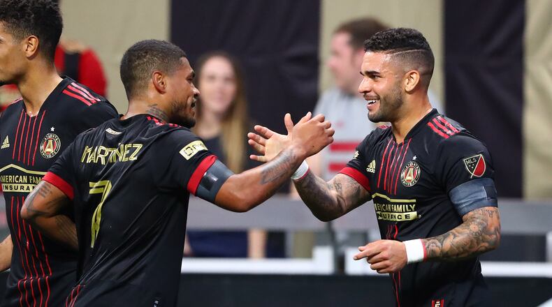 022722 : Atlanta United attacker Dom Dwyer (right) gets five from fellow attacher Josef Martinez after scoring a goal for a 2-0 lead over Sporting KC in a MLS soccer match on Sunday, Feb. 27, 2022, in Atlanta. “Curtis Compton / Curtis.Compton@ajc.com”`