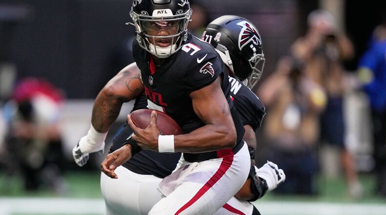 Atlanta Falcons quarterback Michael Penix Jr. (9) drops back against the Carolina Panthers in the first half of an NFL football game, Sunday, Nov. 16, 2025, in Atlanta. (AP Photo/Brynn Anderson)