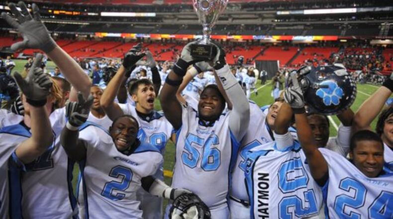Camden County lineman Jeremiah Booth holds the Class 5A trophy after the Wildcats defeated Northside Warner Robins. Camden announced Jon Lindsey, whose first stint at Camden was from 2005 to 2010, as its new head football coach on Friday. (AJC 2009)