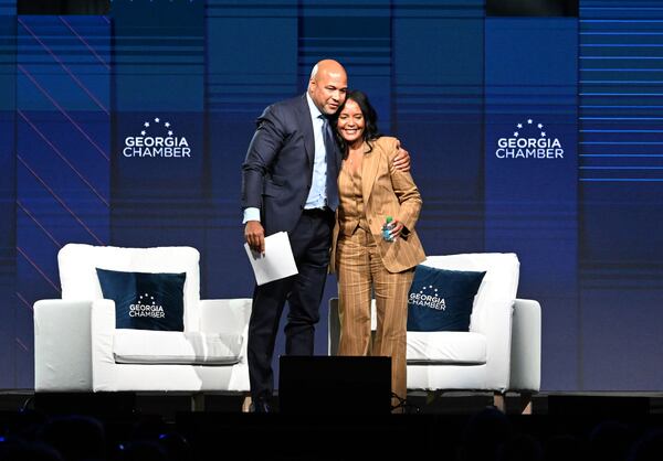 Democratic nominee for governor Keisha Lance Bottoms (right) gets a hug from moderator Tharon Johnson, founder and CEO of Paramount Consulting Group, after speaking during the Georgia Chamber’s annual congressional luncheon on Wednesday in Athens. (Hyosub Shin/AJC)
