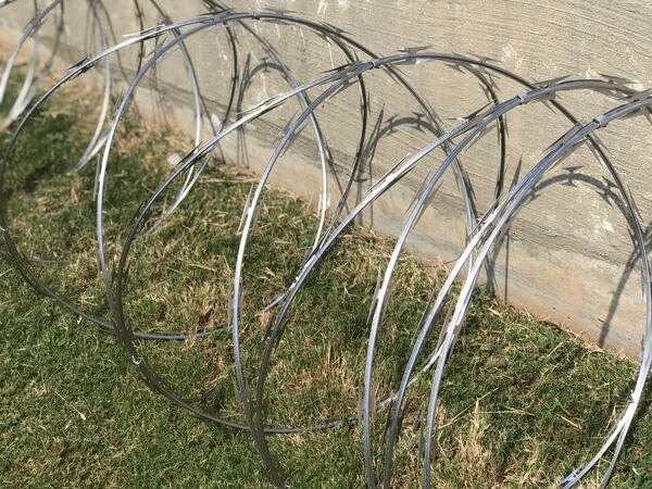 Hartsfield-Jackson officials display a coil of the concertina wire at a press conference.