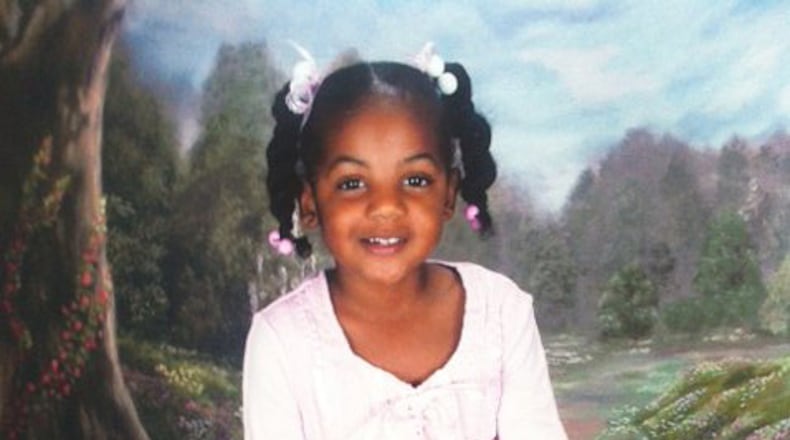 Ten-year-old Emani Moss weighed just 32 pounds when her charred body was discovered in a trash can on Nov. 2, 2013, a Gwinnett County detective testified at a probable cause hearing for her father, Eman Moss and stepmother Tiffany Moss.