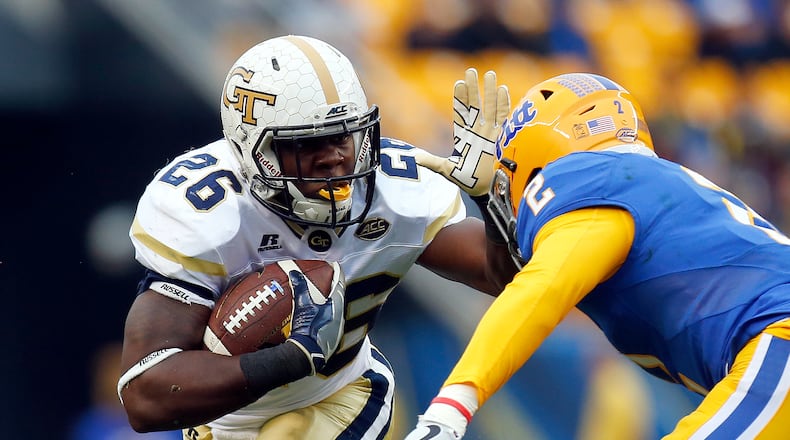 PITTSBURGH, PA - OCTOBER 08: Dedrick Mills #26 of the Georgia Tech Yellow Jackets rushes in the first half during the game against Terrish Webb #2 of the Pittsburgh Panthers on October 8, 2016 at Heinz Field in Pittsburgh, Pennsylvania. (Photo by Justin K. Aller/Getty Images)