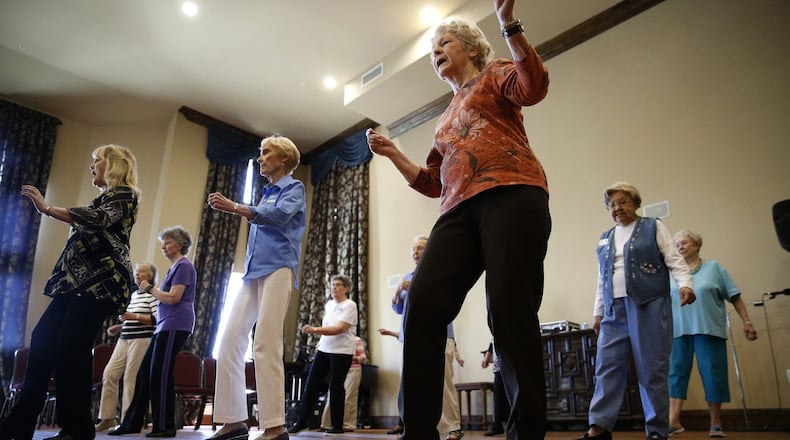 Sarah Winlock (in orange) dances during a line dancing class for seniors at Atria Canyon Creek in Plano, Texas on April 16, 2018. (Nathan Hunsinger/Dallas Morning News/TNS)