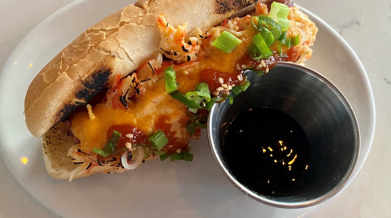 TKO sells the Volcano Dog, a fried beef hot dog topped with spicy imitation-crab salad, which is torched and drizzled with spicy mayo, eel sauce and Sriracha. Wendell Brock for The AJC