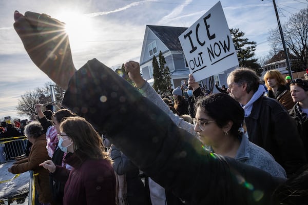 Protesters gather near a shooting involving a federal immigration officer in Minneapolis on Wednesday. An ICE officer is accused of killing a woman during an enforcement operation, the Department of Homeland Security said. (David Guttenfelder/The New York Times)