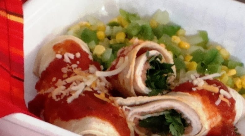 This Mexican-inspired turkey and refried bean enchiladas dish, here in a 2008 file image, takes just five minutes in the microwave. (Linda Gassenheimer/TNS)