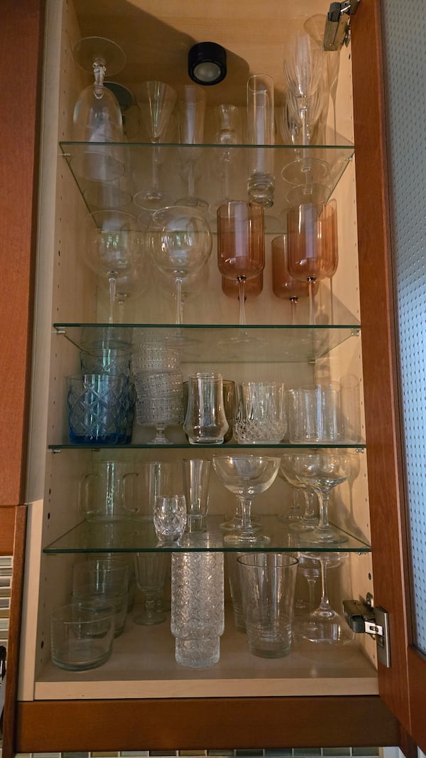 Tiffanie Barriere's glassware collection fills up cabinets in her kitchen. She estimated she has more than 100 glasses. (Courtesy of Tiffanie Barriere)