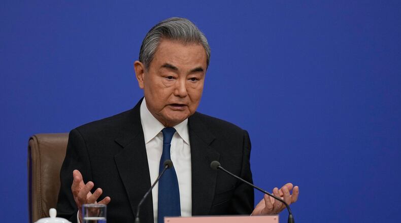 Chinese Foreign Minister Wang Yi speaks during a press conference on the sideline of the National People's Congress (NPC) at the media center, in Beijing, Sunday, March 8, 2026. (AP Photo/Andy Wong)