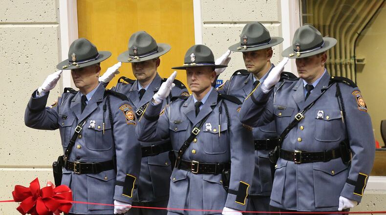 AMERICUS: A honor guard salutes as Georgia Southwestern State University campus police officer Jody Smith is escorted into the Storm Dome for his funeral service at the university on Wednesday, Dec. 14, 2016, in Americus. Officer Smith and Americus police officer Nicholas Ryan Smarr, who were best friends, were killed responding to a domestic dispute. Curtis Compton/ccompton@ajc.com