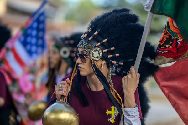 Josie Esquivel along with members of the Danza Señor San Jose dance group performs behind El Santuario De Chimayo in Northern New Mexico on Good Friday, April 18, 2025. Chimayo, N.M. (AP Photo/Roberto E. Rosales)