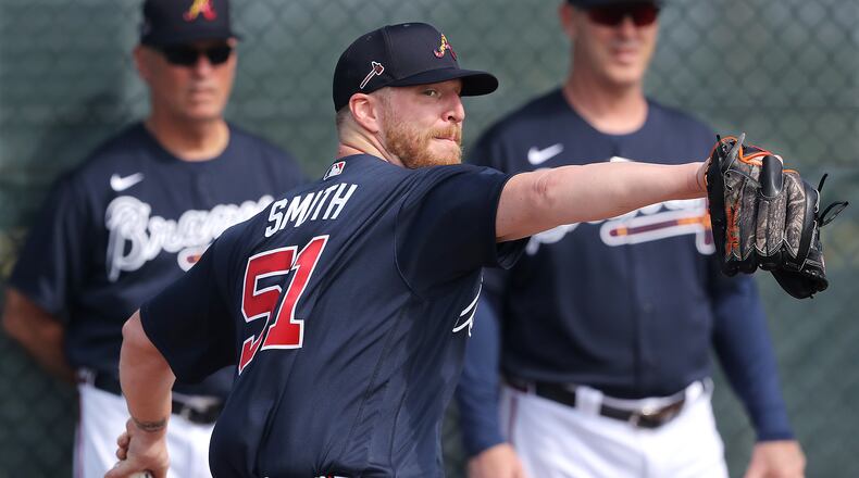 Under the watchful eyes of Braves manager Brian Snitker (background, left) and bullpen coach Marty Reed (background, right) new reliever Will Smith works from the mound during the first workout at CoolToday Park  Thursday, Feb. 13, 2020, in North Port, Fla.