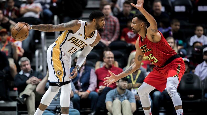 Indiana Pacers forward Paul George (13) controls the ball while defended by Atlanta Hawks forward Thabo Sefolosha (25) during the first quarter of an NBA basketball game, Sunday, March 5, 2017, in Atlanta. (AP Photo/Branden Camp)