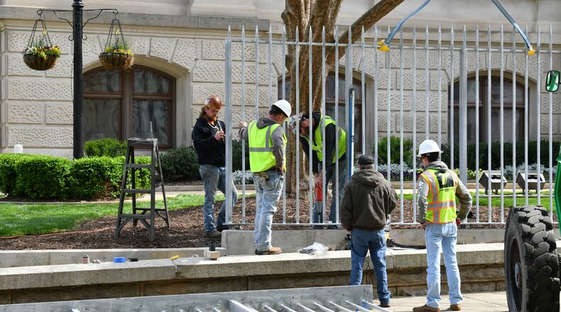 Workers install metal fences outside the Georgia Capitol building on Tuesday, March 30, 2021, the day before Sine Die, the final date for a bill to be passed by both chambers of the Legislature before being sent to the governor for his signature. (Hyosub Shin / Hyosub.Shin@ajc.com)