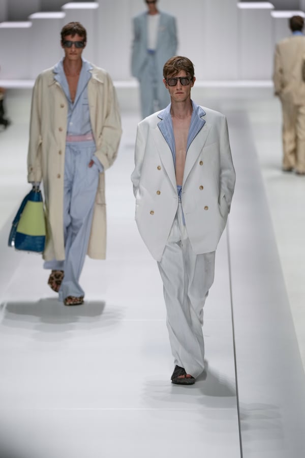 Models wear creations as part of the men's Dolce & Gabbana Spring-Summer 2026 collection, that was presented in Milan, Italy, Saturday, June 21, 2025. (AP Photo/Luca Bruno)