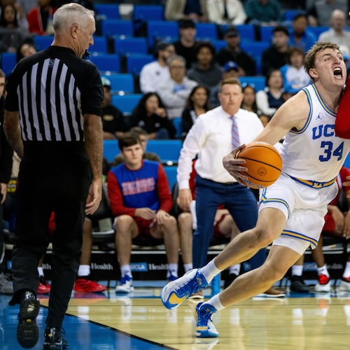 UCLA forward Tyler Bilodeau (34) is defended by West Georgia forward Kenneth Chime, right, during the first half of an NCAA college basketball game Monday, Nov. 10, 2025, in Los Angeles. (AP Photo/Ethan Swope)