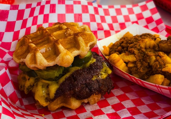 A double-patty burger with Liege waffle bun at NFA Burger Avalon. (Henri Hollis/AJC)