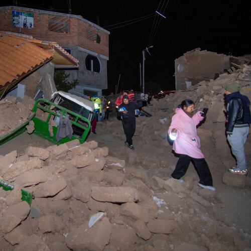 Residents walk amid the debris of homes that collapsed after an earthquake struck Pumpuya, Peru, Sunday, July 19, 2026. ( AP Photo/Javier Ninanya)