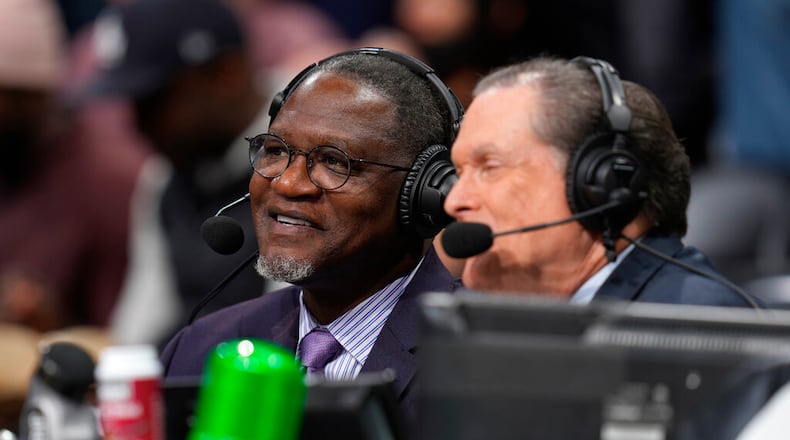 Hawks television analyst Dominique Wilkins (left) works during the first half of an NBA basketball game Nov. 12, 2021, in Denver. (AP Photo/David Zalubowski, File)
