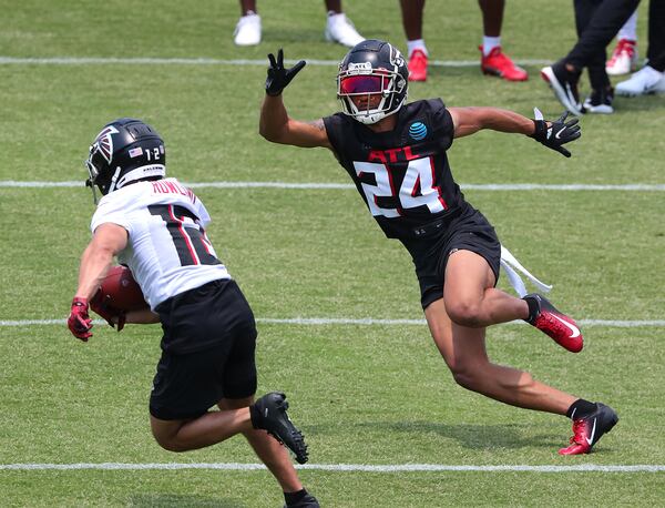 Falcons cornerback A.J. Terrell (24) makes an athletic move to cover wide receiver Chris Rowland during OTAs on Tuesday, May 25, 2021, at the team training facility in Flowery Branch. (Curtis Compton / Curtis.Compton@ajc.com)