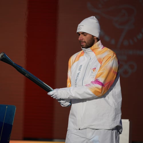 Italian swimmer Gregorio Paltrinieri lights the 2026 Milan Cortina Winter Olympics torch in Rome as it begins its journey through Italy, Saturday, Dec. 6, 2025, a journey that will conclude in Milan in February 2026. (AP Photo/Andrew Medichini)